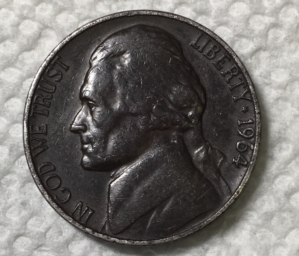 1964 Black Beauty nickel with dark charcoal improper annealing toning alongside normal 1964 nickel for comparison